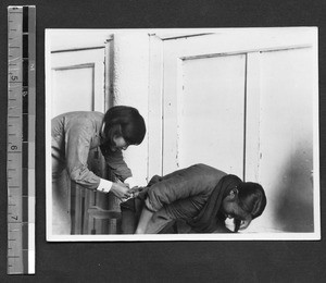 Nurse treating a woman at rural service center of Fukien Christian University, Fuzhou, Fujian, China, 1936