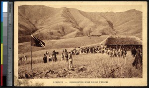 Men and women gather around a flag near a church, Lesotho, ca.1900-1930