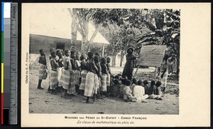 Missionary father teaches math to children, Congo Republic, ca.1900-1930