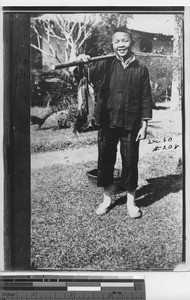 A mission school boy with fish at Dongzhen, China