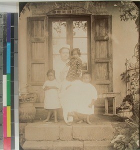 Ragnhild Soerensen on the hospital steps with three small Malagasy children, Antsirabe, Madagascar, 1916