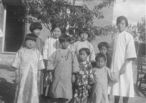 Blind home Blind School in Mukden. Miss Yü with a flock of the latest children. Applied 1933