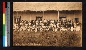 Christians assembled outside of a thatch-roofed building, Angola, ca.1920-1940