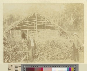 Men outside wooden house structure, Kikuyu, Kenya, ca.1901