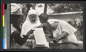 Missionary sisters weighing a child, Congo, ca.1920-1940