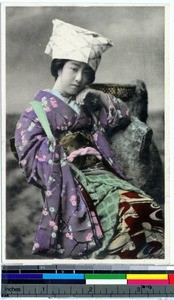 Portrait of a young Japanese woman sitting in a chair, Japan, ca. 1930-1950