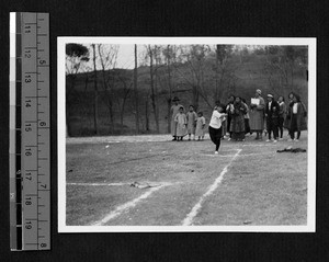 Ginling College student throwing discus, Nanjing, Jiangsu, China, 1932