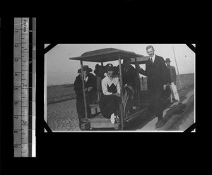 Missionaries riding pushmobile, Shantou, Guangdong, China, 1921