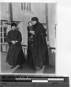 Maryknoll Sister holding a Chinese baby at Dalian, China