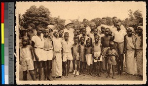 Missionary standing with young victims of leprosy, Congo, ca.1920-1940