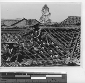 Chinese workers repairing the roof at the Mission at Gaozhou, China, 1938