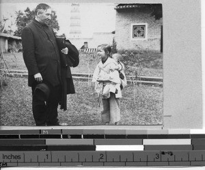 Bishop James A. Walsh, MM with a child at Luoding, China, 1931