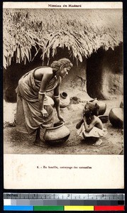 Mother and daughter cleaning pots, Madura, India, ca.1920-1940