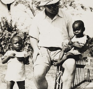 Male missionary and two children, Christmas, Nigeria, 1938