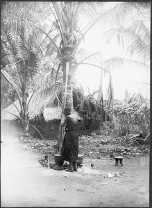 Woman stamping maize, Gonja, Tanzania, ca. 1927-1938