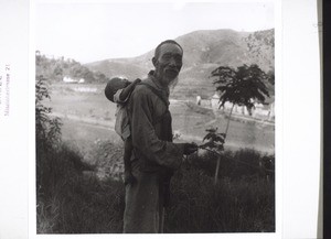 Grandfather with a sleeping child on his back