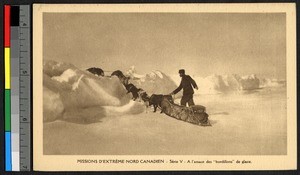 Man guiding dog sled over a bank of snow, Canada, ca.1920-1940