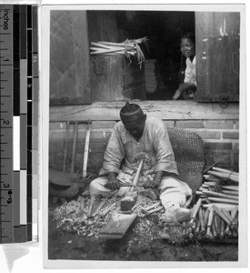 Man making ironing sticks, Korea, ca. 1920-1940