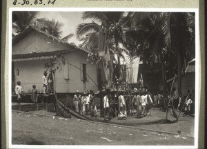 Tiwa festival in Puruk Tjahu. The bull is in the cage. The Blian and others dance around it