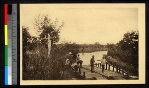 Missionary and four men on a docked raft, Cote d'Ivoire, ca.1920-1940