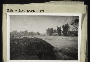 Around the town of Hinnen trenches were built for defence. This is a trench for a machine-gun. The mission station is in the background behind the three bamboos