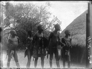 African boys carrying spears and shields, Matutwini, Mozambique, ca. 1930