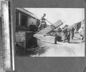 Construction workers sawing a wood beam, Beijing, China, ca.1900-1910