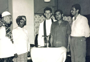 Verner Tranholm-Mikkelsen at the baptismal font with left Mubarak Ibrahim, Ahmad and right Moha