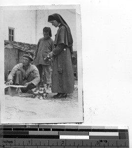 A Maryknoll Sister bargains for kerosene at Dongshi, China, 1948