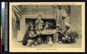 Family eating at a low table attended by a servant, Egypt, ca.1900-1930