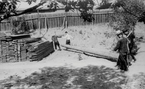 The timber for the new church is carried into the church square. The picture has been used in 1