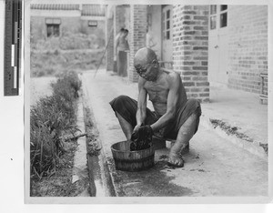 A man washing clothes at leprosarium at Jiangmen, China, 1949