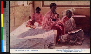 People sitting by a bed in a hospital ward, Khammamett, India, ca.1920-1940