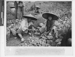 A Chinese mother and daughter help repair a road at Guizhou, China, 1942