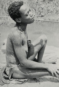 Woman smoking, in Gabon