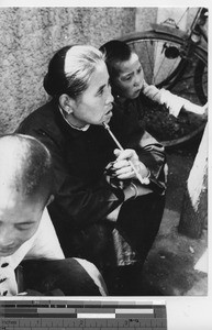 A Woman smoking a pipe at Fushun, China, 1939