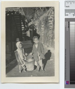 Two small children carrying pail, China, ca.1888-1929