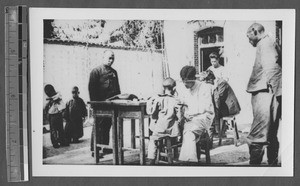 Medical student examining child, Jinan, Shandong, China, ca.1940