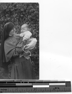 Sister Moira with orphan at Luoding, China, 1935