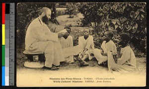 Missionary father reading to children, Tanzania, ca.1920-1940