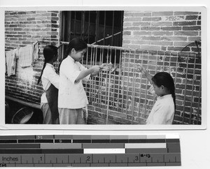 Orphans making candles at Luoding, China, 1935