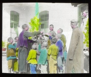 Fr. Anthony Cotta, MM, with a group of children, China, ca. 1906-1919