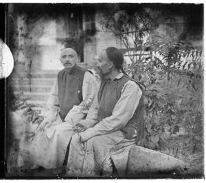 Fr. Vincent Lebbe and Fr. Anthony Cotta, MM, seated outside a building, China, ca. 1906-1919