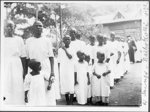 Leonhard Blumer with African women and girls in festive dress, Arusha, Tanzania, 1927