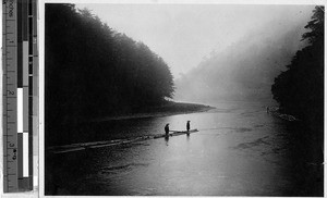 Two men guiding a log float down a river, Japan, ca. 1920/1940