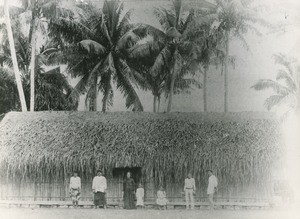 In Tahiti, a native minister and his wife, in front of their house