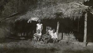 Native family in front of its hut, in Cameroon