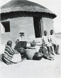 A Basotho family in front of its hut