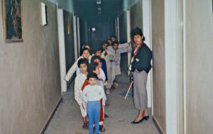 Bedtime for the youngest children in Fowler's orphanage 1992. The elderly girls helps. The disc