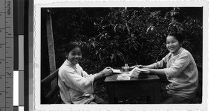 Two girls making cards, Loting, China, ca. 1935